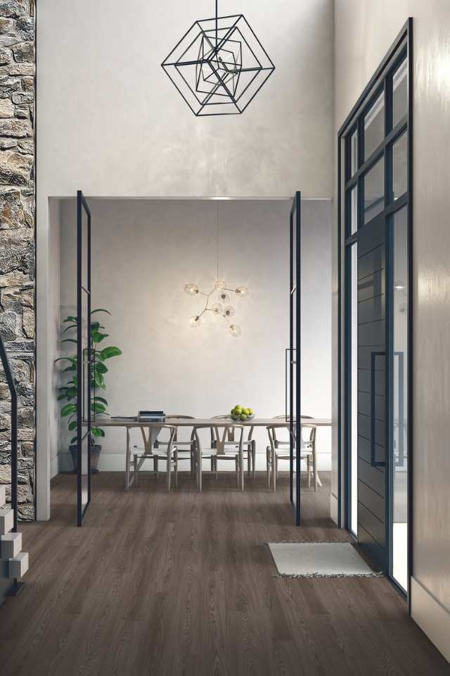 grey wood look in entryway of contemporary home with tall ceilings and geometric statement lighting